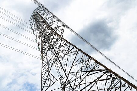 Pylons and cables silhouetted against sky and clouds