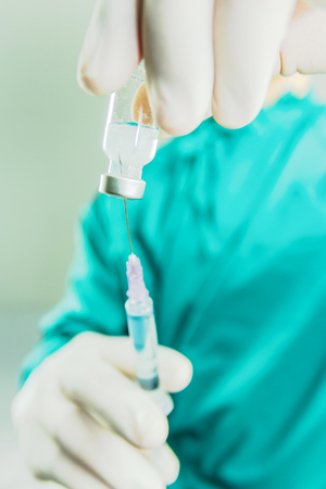 Doctor in surgery are preparing medicine in the syringeの写真素材