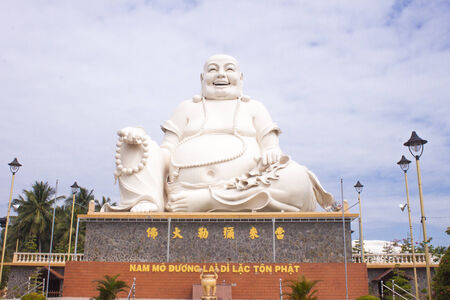 A white buddha statue, at a templeの写真素材