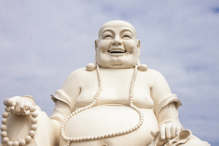 A chubby white buddha statue, in Vietnamの写真素材