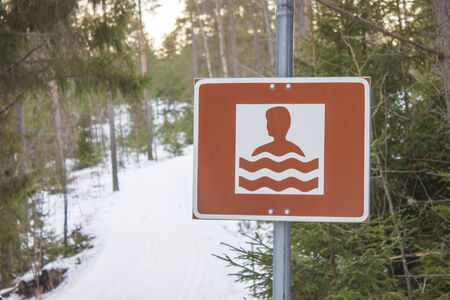 A swim sign in snowy, ice cold januaryの写真素材