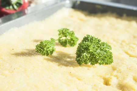 Fresh, green parley on yellow polenta
