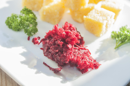 A pile of grated beetroot, near polenta, parsley and avocadoの写真素材