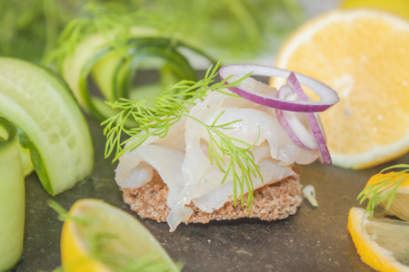 Raw spiced white fish, between cucumbers, lemons, dill and limeの写真素材