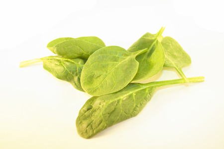 A pile of green spinach, isolated on white background