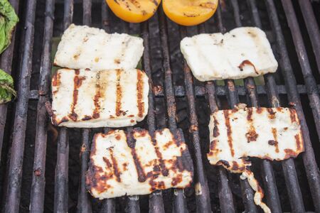 A lot of grilled halloumi, on a barbeque