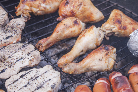 Grilled chicken and other meat, on a barbeque