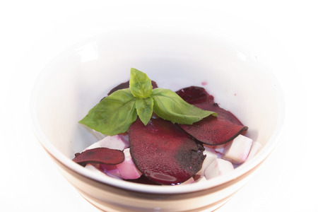 Beetroot and feta salad, with basil, isolated on white backgroundの写真素材