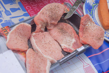 A plate full of pork sirloin, at a tableの写真素材