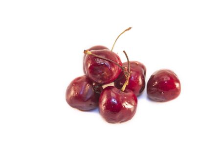 A pile of old red cherries, isolated on white backgroundの写真素材