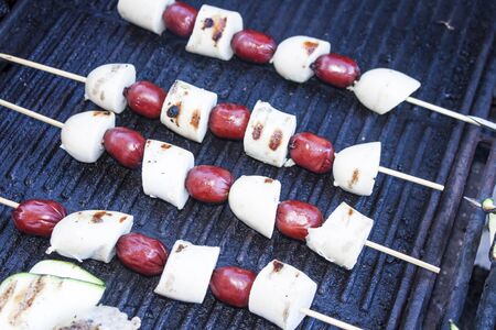 Grilling sausage and bratwurst skewers, on a gas barbequeの写真素材