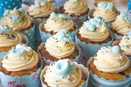 It is a boy, A lot of blue baby shower cupcakes, decorated with baby stuffの写真素材