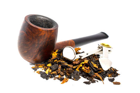 Smoking briar pipe with tobacco and czech tool on a white background