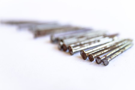 Several nails rust on a white background.