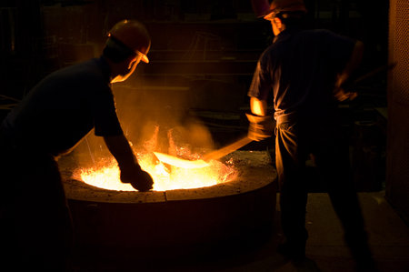 Metal industry, molten metal being poured into a furnace in a foundry