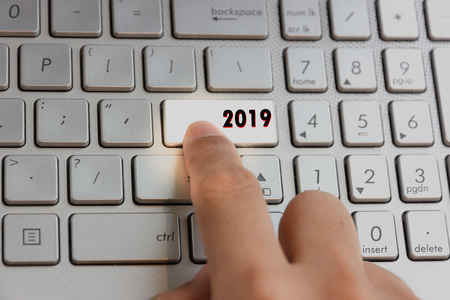 finger pressing keyboard key written 2019 new year on laptopの写真素材
