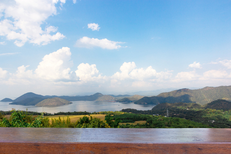 Empty wood table top on Nature scene of Srinagarind Dam with cloudy sky at kanchanaburi ,Thailandの写真素材