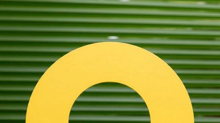 Title: showing title: bright yellow arch against blurred green horizontal striped background. resolution use.の素材