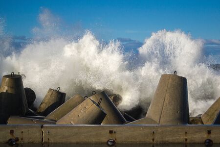 Concrete breakwater at the coast of Baltic sea, protection for the shore structure against high wavesの写真素材