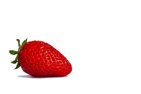 Single red strawberry fruit, closeup photo isolated on white backgroundの写真素材