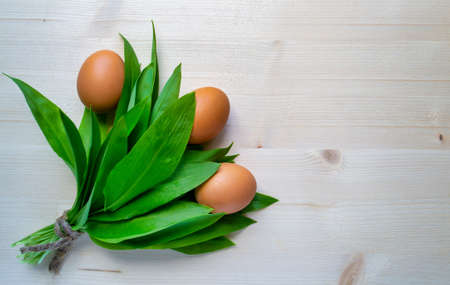 Ramson with eggs on bright wooden background