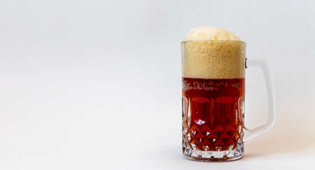 Glass mug full of a red beer with a foam capの写真素材