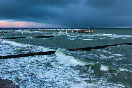 impending thunderstorm over the sea at sunset timeの写真素材