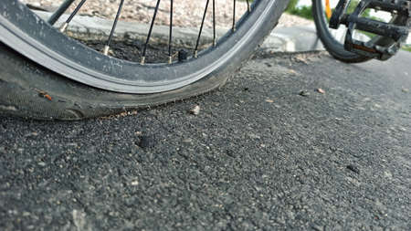 The flat tire of a bicycle closeup photoの写真素材