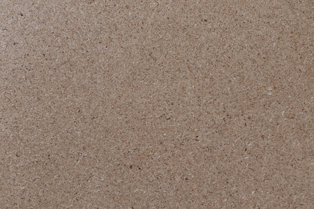 chipboard closeup, texture of a pressed wooden particleboard panel background
