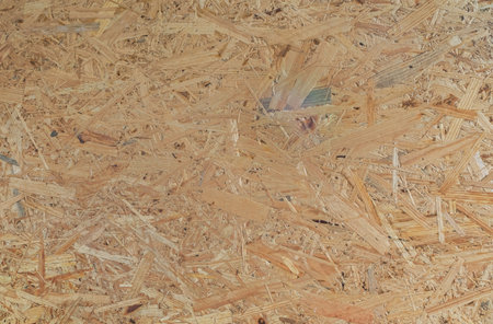 osb board closeup, texture of characteristic for an oriented strand board wood strands. Pressed wooden board panel backgroundの写真素材