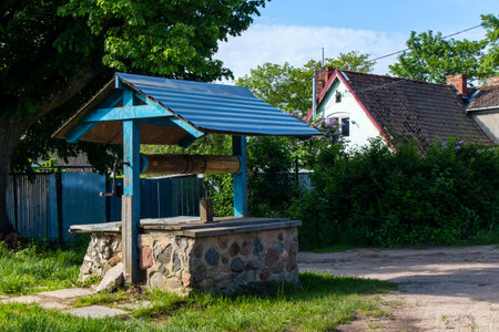 water well with a turnstile and gable roofの写真素材