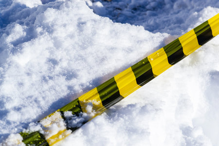Warning tape stretched across fresh snowの写真素材