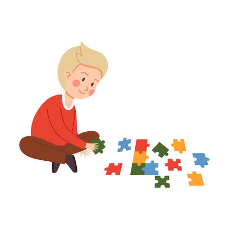 Vector flat cartoon character illustration of smiling child boy who sits on floor and solves multi-colored puzzle and pieces of different shapes. Illustration is isolated on white background.のイラスト素材
