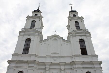 White catholic church's front on cloudy day