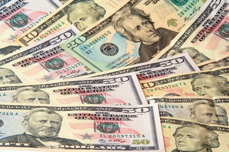 Mixed nominal dollar banknotes lying growing can be used as background