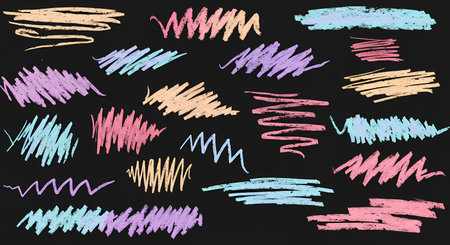 A vibrant collection of hand-drawn pastel chalk scribbles on a textured black background. The abstract marks in pink, blue, and orange create a playful, artistic design element.の素材