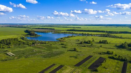 Aerial landscape of Russian countryside, rural scene. lush green foliage, beautiful lake, high angle view, summer season.の写真素材