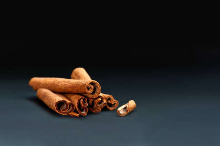 Cinnamon sticks on grey and black backgroundの写真素材