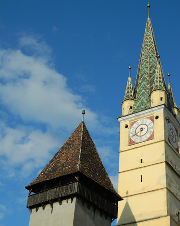 Medieval German Lutheran church of Medias, detail of the clock tower, Medias, Romania with smaller tower next to it.の写真素材