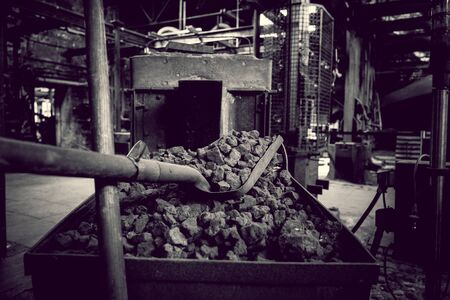 old workshop with tools and coals and machinery with gloomy admonsphere in black and white