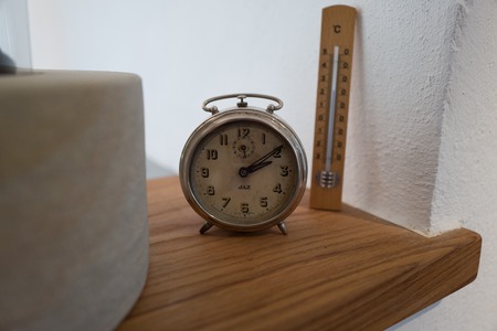 Clock in an old workshop with temperature scale in backgroundの写真素材