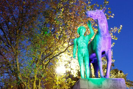 Statue man with horse blue green illuminated, Hannoverの写真素材