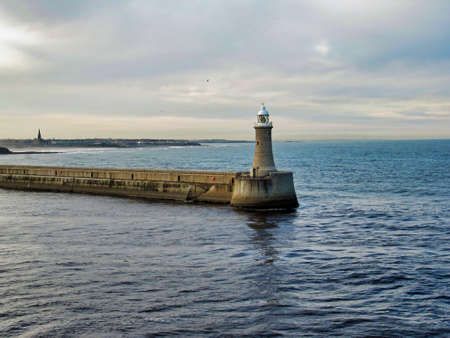 Lighthouse at the end of the pier of Newcastle Harbor on the River Tyne, UKの写真素材