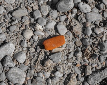 A red stone on a stony groundの写真素材