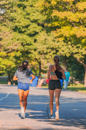 two people running in the parkの写真素材