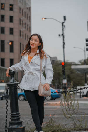 Vertical shot of a Caucasian (white) girl posing for the camera outside in United Statesの写真素材