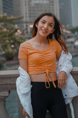 Vertical shot of a Caucasian (white) girl posing for the camera outside in United Statesの写真素材
