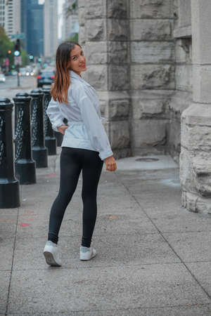 Vertical shot of a Hispanic girl posing for the camera outside in United Statesの写真素材