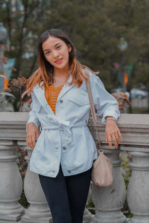 Vertical shot of a Caucasian (white) girl posing for the camera outside in United Statesの写真素材