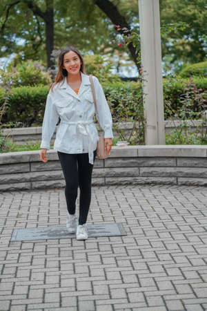 Vertical shot of a Caucasian (white) girl posing for the camera outside in United Statesの写真素材